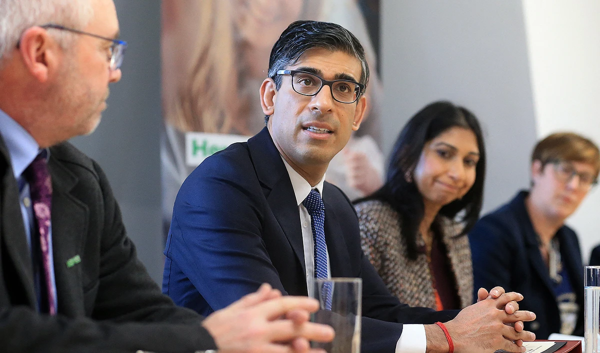 Britain's Prime Minister Rishi Sunak (2L), and Britain's Home Secretary Suella Braverman (2R) sit with National Society for the Prevention of Cruelty to Children (NSPCC) CEO Peter Wanless (L) take part in a meeting of the Grooming Gang Taskforce, during a visit to the offices of the NSPCC in Leeds, northern England, on April 3, 2023. (Photo courtesy: AFP)