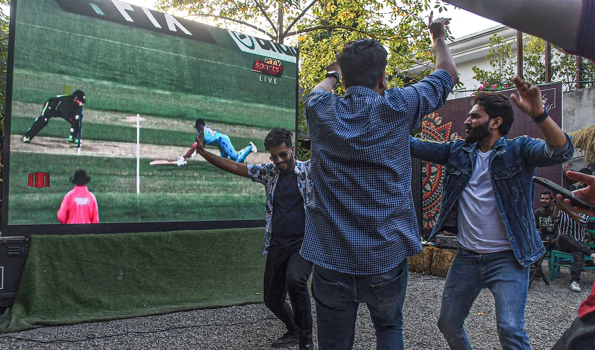 Pakistani cricket fans react while watching the ICC men's Twenty20 World Cup 2022 cricket match between India and Pakistan, on a screen in Lahore on October 23, 2022. (AFP/File)