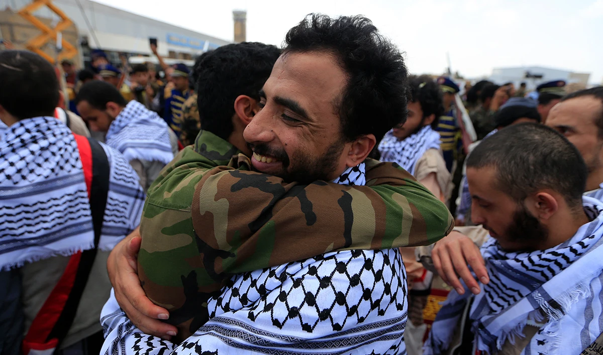 A Yemeni Huthi rebel former prisoner is welcomed upon his arrival at Sanaa airport, on April 16, 2023. Yemeni rebels and government forces freed scores of prisoners on April 16 to end a three-day exchange of nearly 900 detainees and boost hopes of ending their protracted civil war. (AFP/File)