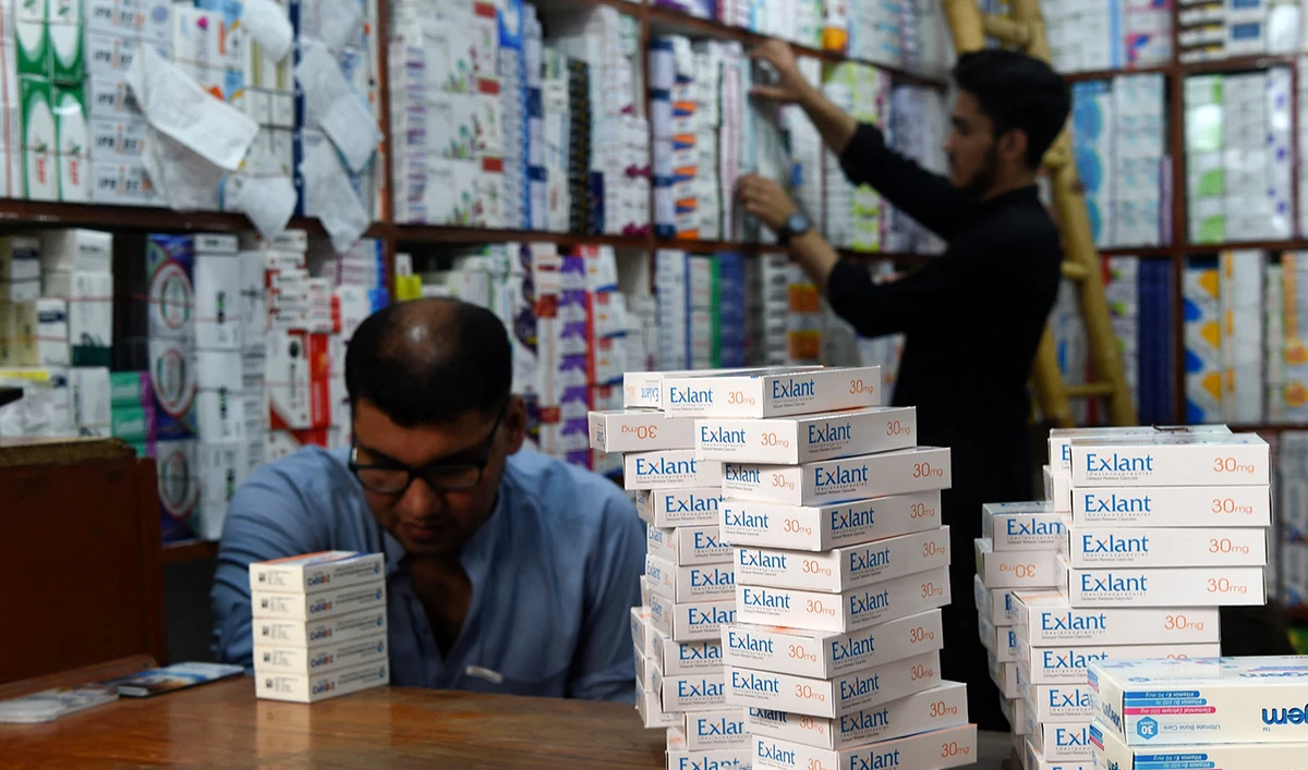 Pharmacists arrange medicines at a pharmacy shop in Peshawar on September 1, 2021. (AFP/File)
