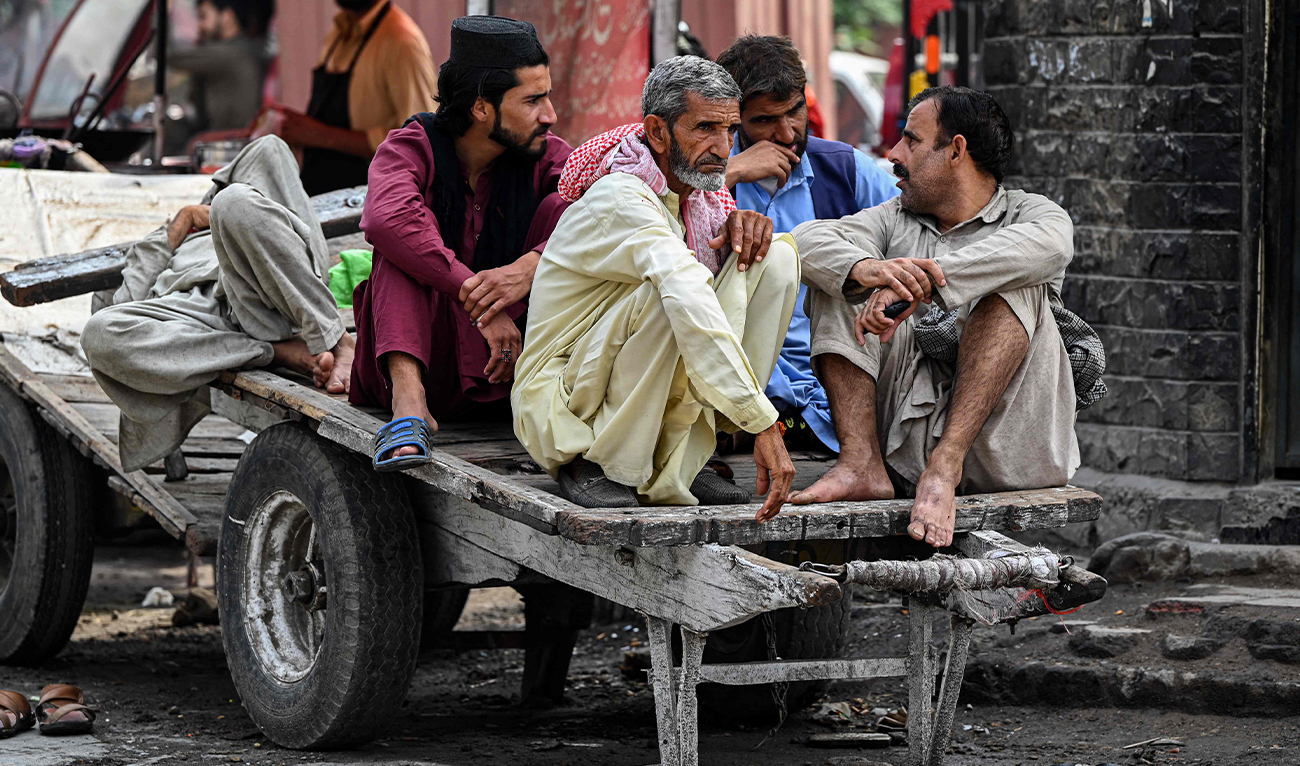 Daily wage labourers wait for customers to hire them at Raja bazaar in Rawalpindi, Pakistan, on May 1, 2023. (AFP)