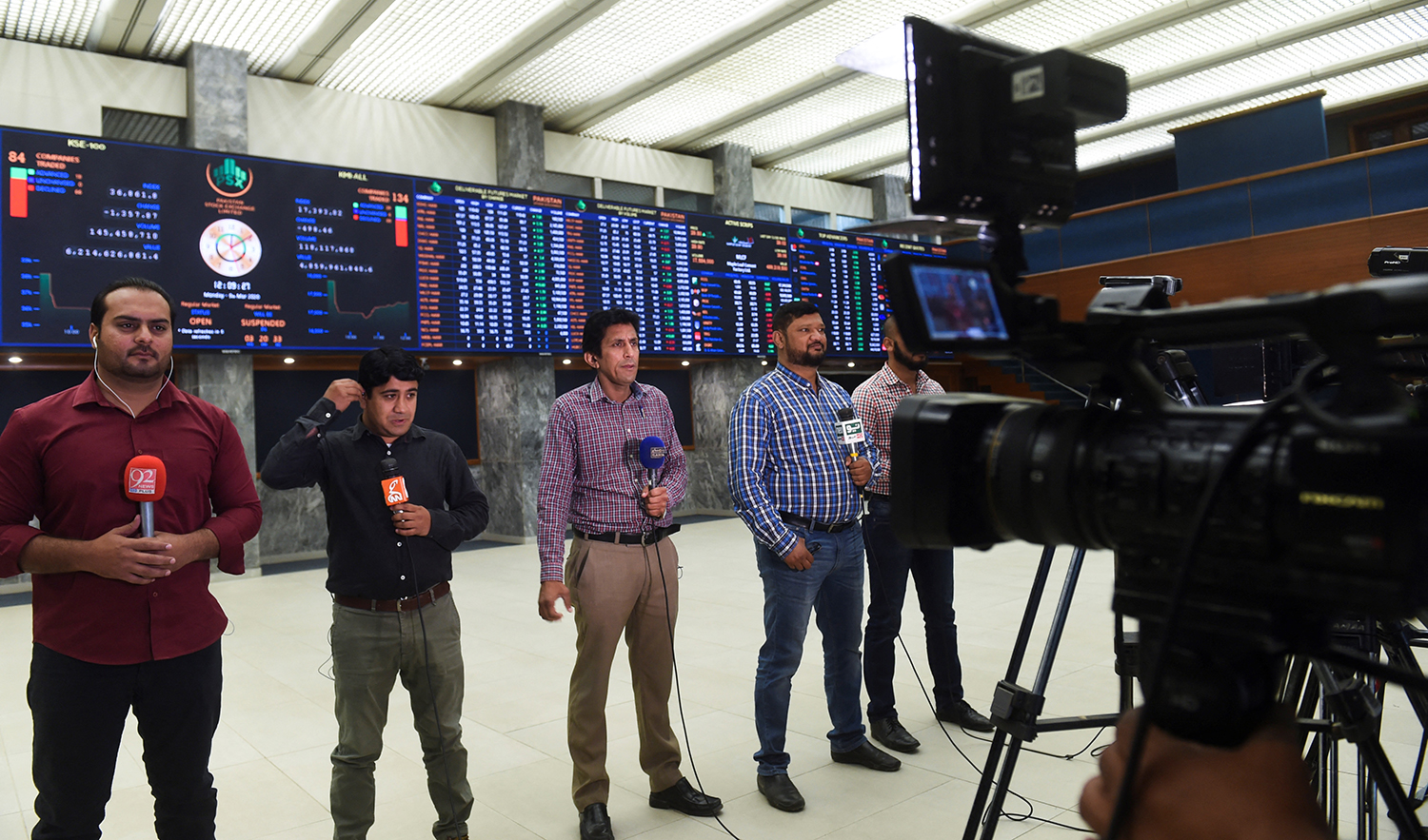 Journalists report from the trading floor at the Pakistan Stock Exchange (PSX) in Karachi on March 9, 2020. (AFP/File)