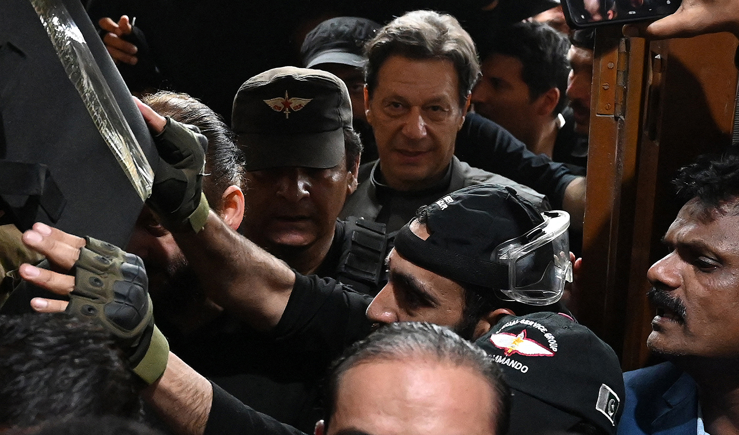 Pakistan’s former prime minister Imran Khan (C) leaves after appearing before a court for a protective bail in relation to two cases, in Lahore on March 21, 2023. (AFP/File)