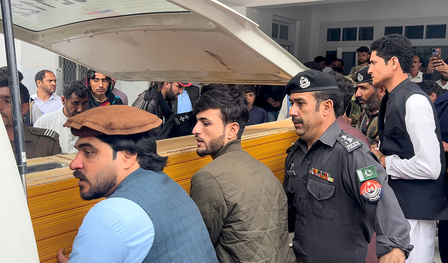 People carry a teacher's dead body into an ambulance from a hospital after a sectarian violence inside a school in Parachinar, in Kurram district of Pakistan's Khyber Pakhtunkhwa province on May 4, 2023. (AFP)