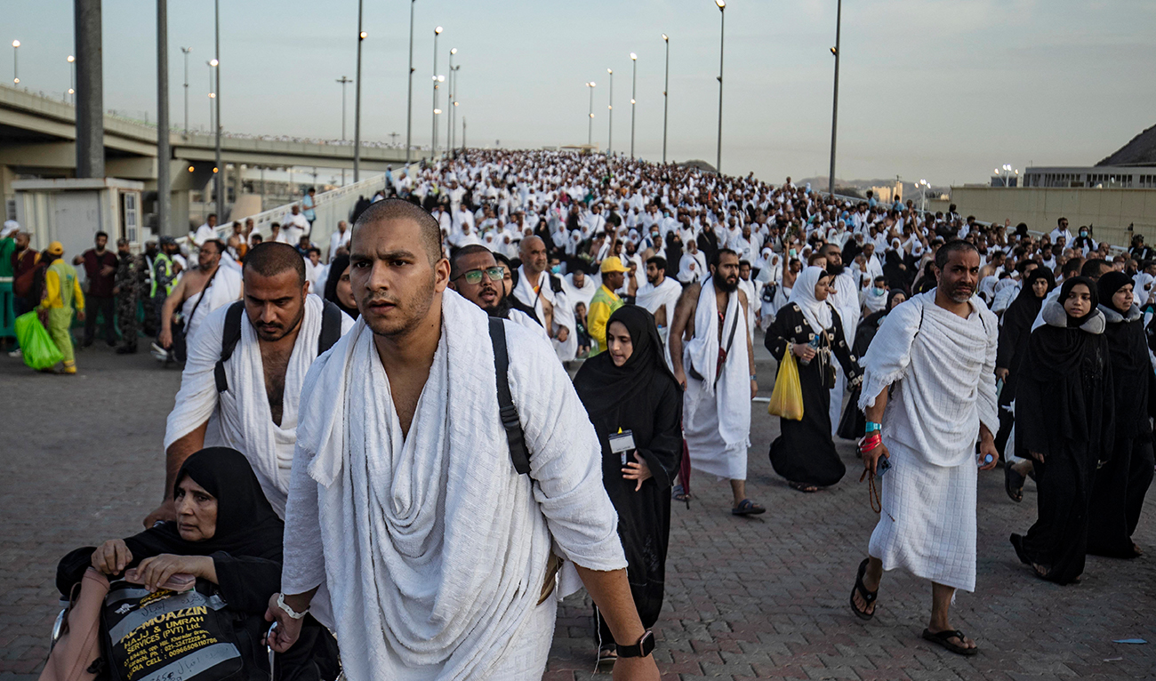 Thousands of Muslim pilgrims make their way across the valley of Mina, near Mecca in western Saudi Arabia, to perform the "stoning of the devil" ritual which marks the start of the Eid al-Adha holiday on July 9, 2022, as this year's expanded hajj pilgrimage was winding down. Worshippers throw stones at three concrete walls representing Satan every year at the end of their pilgrimage to Mecca. (AFP/File)