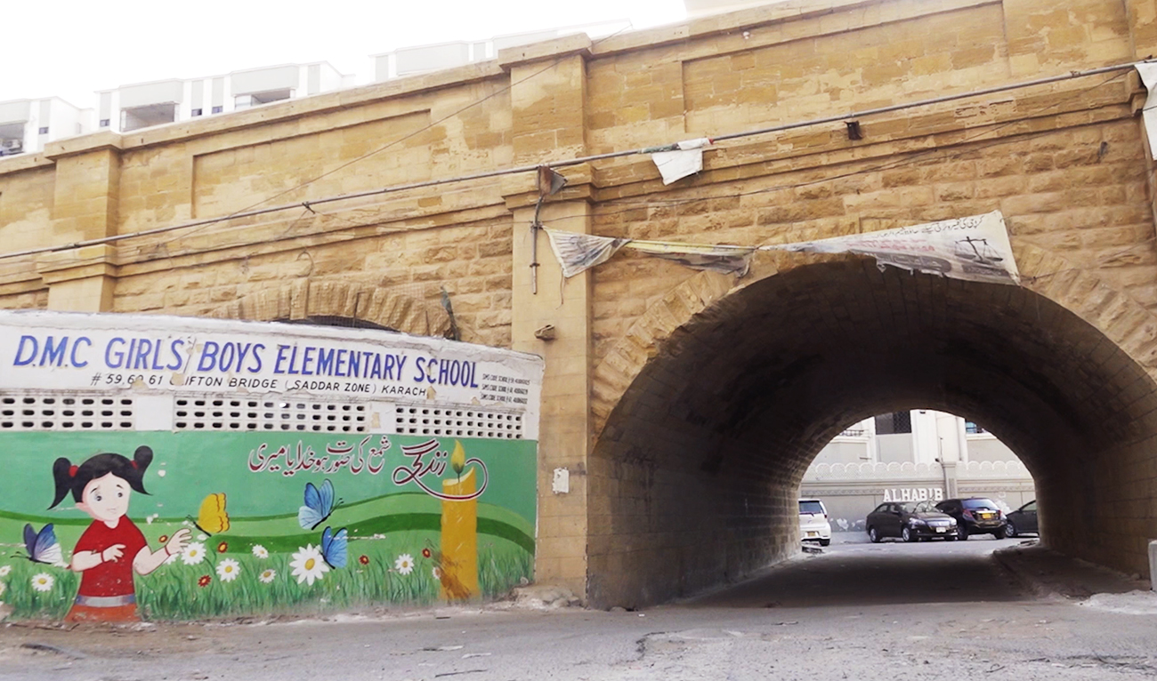 The photo taken on May 5, 2023, shows the Clifton bridge school's name painted on its wall next to the bridge in Karachi, Pakistan. (AN Photo)