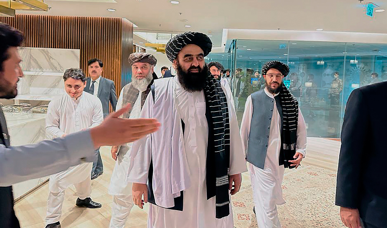 In this photo provided by Afghanistan Embassy in Pakistan, the Taliban-appointed Foreign Minister Amir Khan Muttaqi, center, walks with other officials upon his arrival in airport, in Islamabad, Pakistan, Friday, May 5, 2023. (Photo courtesy: Afghanistan Embassy in Pakistan via AP)