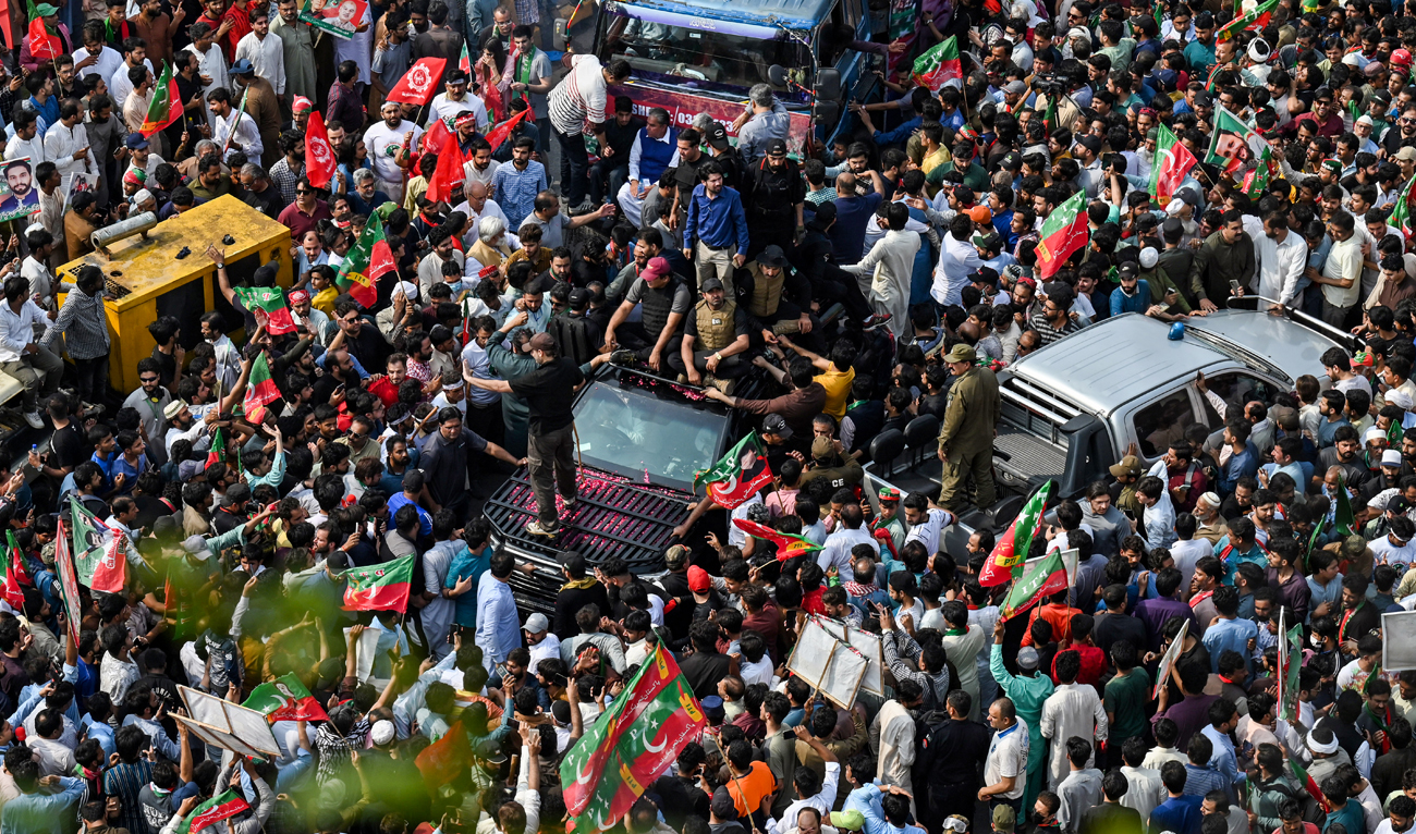 In this picture, taken on May 1, 2023, activists of the Pakistan Tehreek-e-Insaf (PTI) party gather around the vehicle of former prime minister Imran Khan (inside c, vehicle) during a rally in Lahore. (Photo courtesy: AFP)