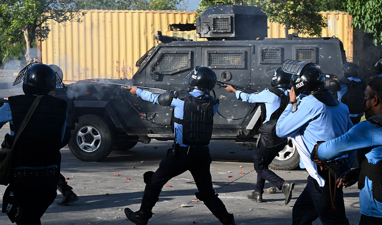 Policemen fire rubber bullets towards Pakistan Tehreek-e-Insaf (PTI) party activists and supporters (unseen) of former Pakistan's Prime Minister Imran Khan during a protest outside the police headquarter where Khan is in custody, in Islamabad on May 10, 2023. (AFP)