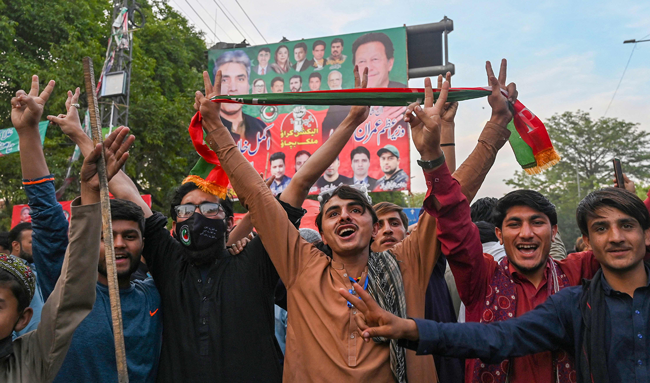Pakistan Tehreek-e-Insaf (PTI) party activists and supporters of Pakistan's former Prime Minister Imran Khan celebrate after Supreme Court declared Khan's arrest "invalid", in Lahore on May 11, 2023. (AFP)