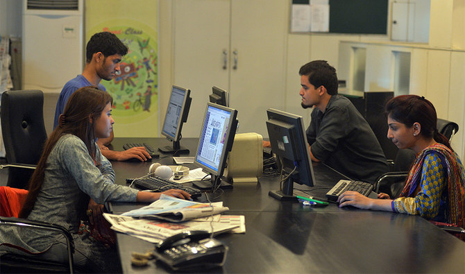 Pakistani staff of Islamabad-based Power 99 FM radio work on their computers at the radio station's office in Islamabad on July 26, 2016. (AFP/File)