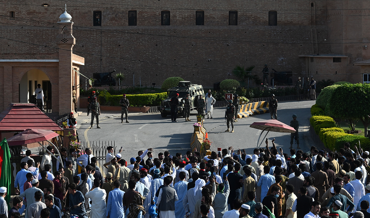 Pakistan Tehreek-e-Insaf (PTI) party activists and supporters of former Pakistan's Prime Minister Imran gather outside headquarters of the frontier corps during a protest against the arrest of their leader, in Peshawar on May 9, 2023. (Photo courtesy: AFP)