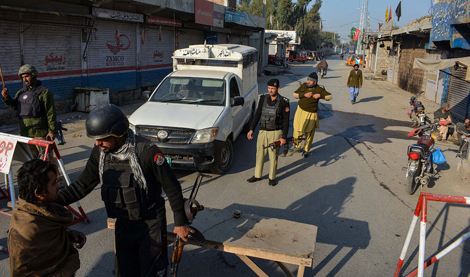 In this picture, taken on December 19, 2022, police stand guard along a road they blocked after Taliban militants seized a police station in Bannu. (Photo courtesy: AFP/File)