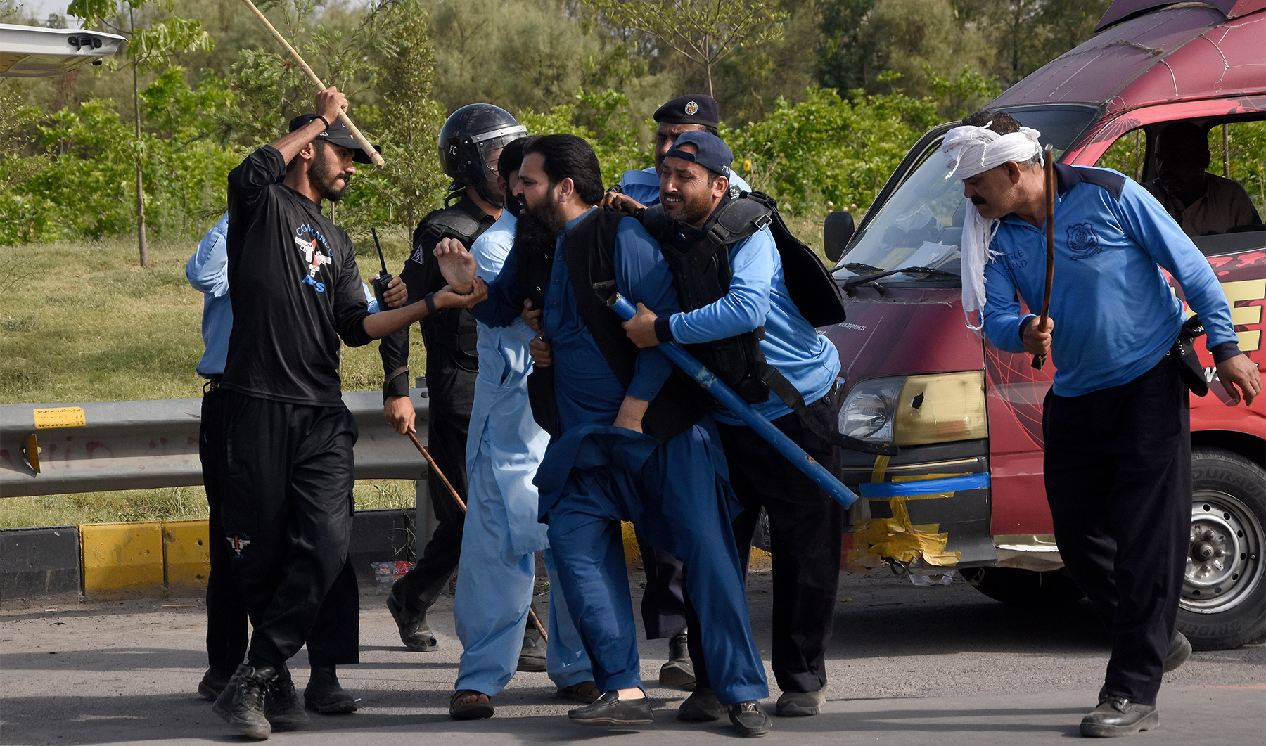 Police detain a supporter of Pakistan's former Prime Minister Imran Khan during clashes, in Islamabad, Pakistan, on May 12, 2023. (AP)