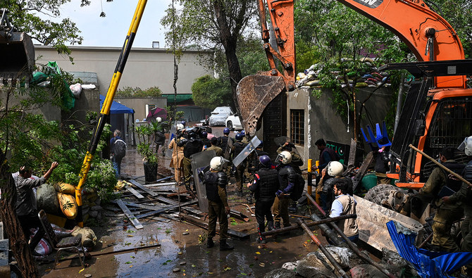 Policemen use heavy machinery to enter Pakistan’s former prime minister Imran Khan's residence in Lahore on March 18, 2023, after Khan left for Islamabad to appear in a court. (Photo courtesy: AFP/File)