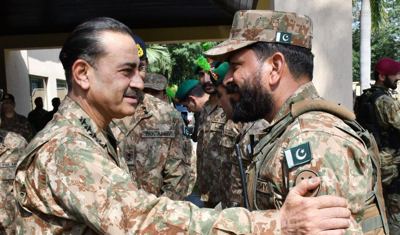 Pakistan's army chief General Syed Asim Munir, greets a soldier on his visit to Sialkot Garrison in Pakistan on May 17, 2023. (Photo courtesy: ISPR/website)