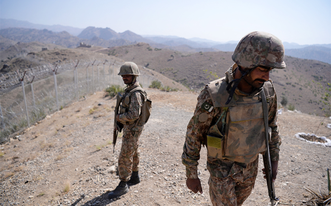 Pakistani soldiers patrol next to a newly fenced border fencing along Afghan border at Kitton Orchard Post in northwest Pakistan on October 18, 2017. (AFP/File)