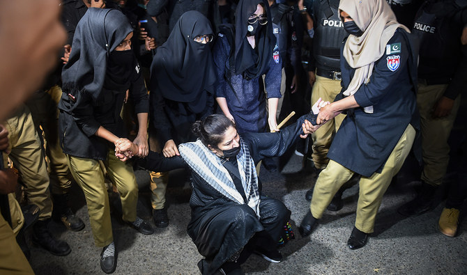 Policewomen detain a Pakistan Tehreek-e-Insaf (PTI) party activist and supporter of former Pakistan's Prime Minister Imran Khan during a protest against the arrest of their leader, in Karachi on May 10, 2023. (AFP/File)