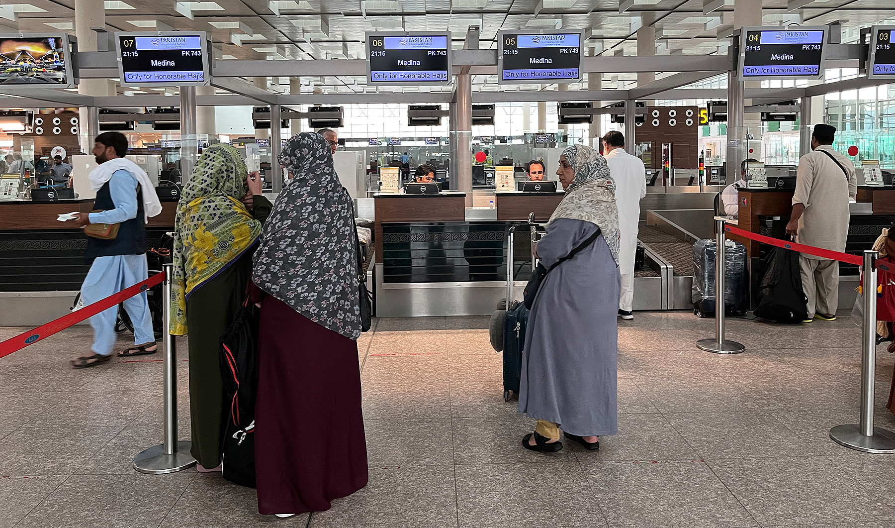Pakistani pilgrims go wait for their boarding pass at Islamabad International Airport in Islamabad, Pakistan, on May 21, 2023, prior to the annual Hajj pilgrimage in the holy city of Makkah. (AN photo by Fatimah Amjad)