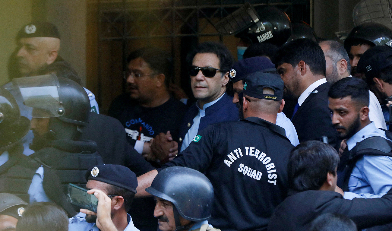 In this picture, taken on May 12, 2023, security officers escort Pakistan's former Prime Minister Imran Khan, as he appeared in Islamabad High Court, Islamabad, Pakistan. (Photo courtesy: REUTERS/File Photo)