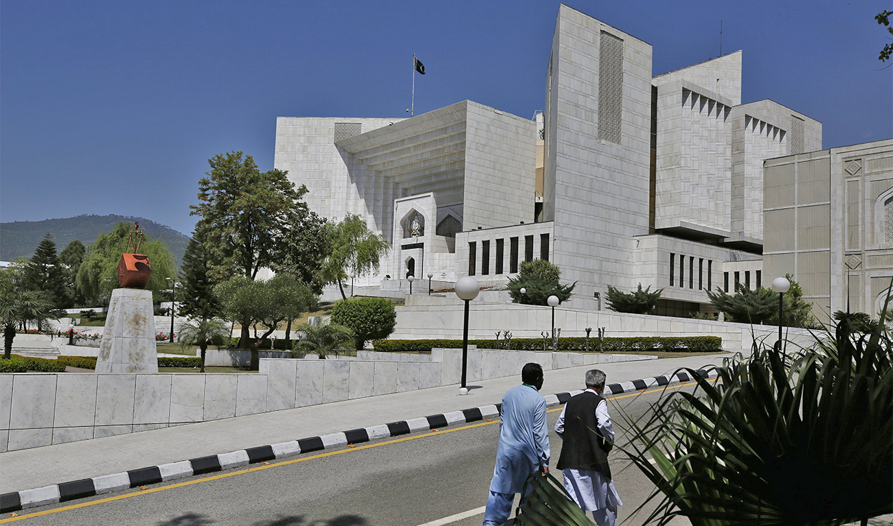 People walk past the Supreme Court of Pakistan in Islamabad, Pakistan, on April 4, 2022. (AP/File)