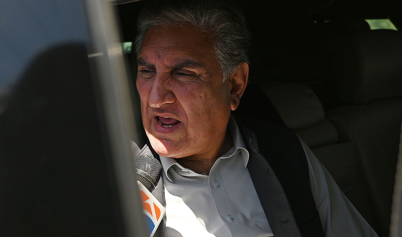 Shah Mahmood Qureshi, deputy head of Pakistan Tehreek-e-Insaf (PTI) party speaks with media as he waits to attend a hearing near the police headquarters where former Pakistan's Prime Minister Imran Khan is being kept in custody and will appear before a special court set-up for his trial, in Islamabad on May 10, 2023. (AFP/File)