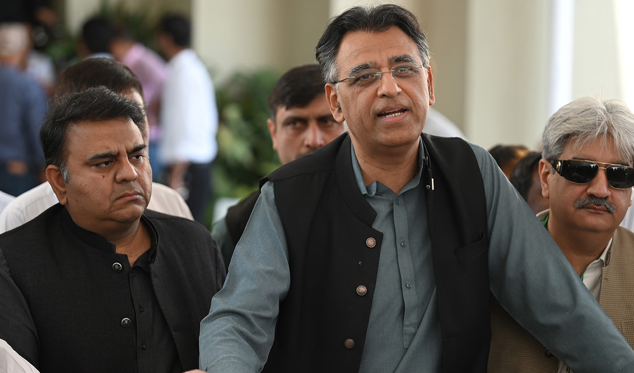 Laders of Pakistan Tehreek-e-Insaf (PTI) party of Prime Minister Imran Khan, Asad Umar (R) and Fawad Chaudhry (L) speak with the media outside the Supreme Court building prior to start a hearing, in Islamabad on April 6, 2022. (AFP/File)