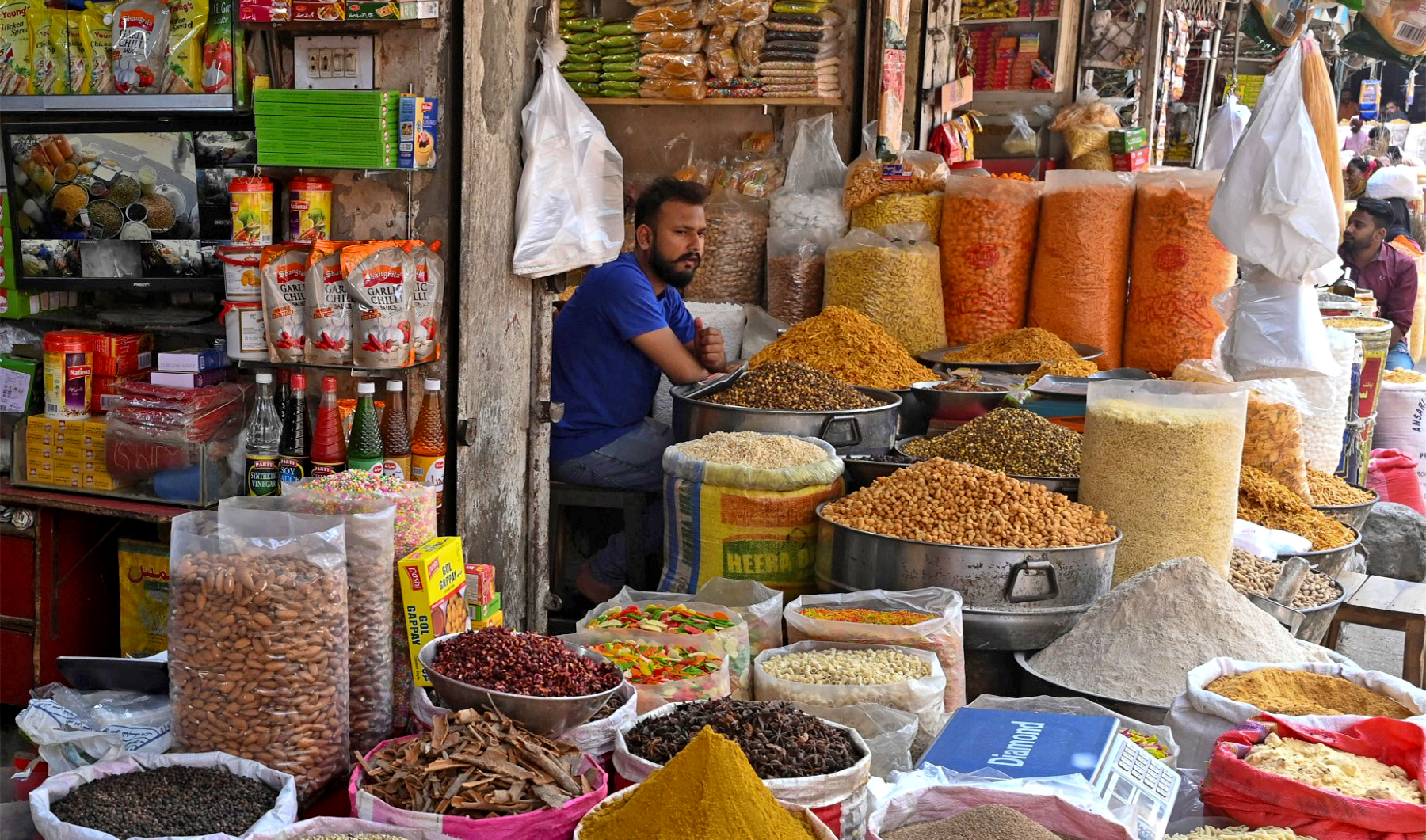 A shopkeeper waits for customers at a market in Lahore, Pakistan, on May 17, 2023. (AFP)