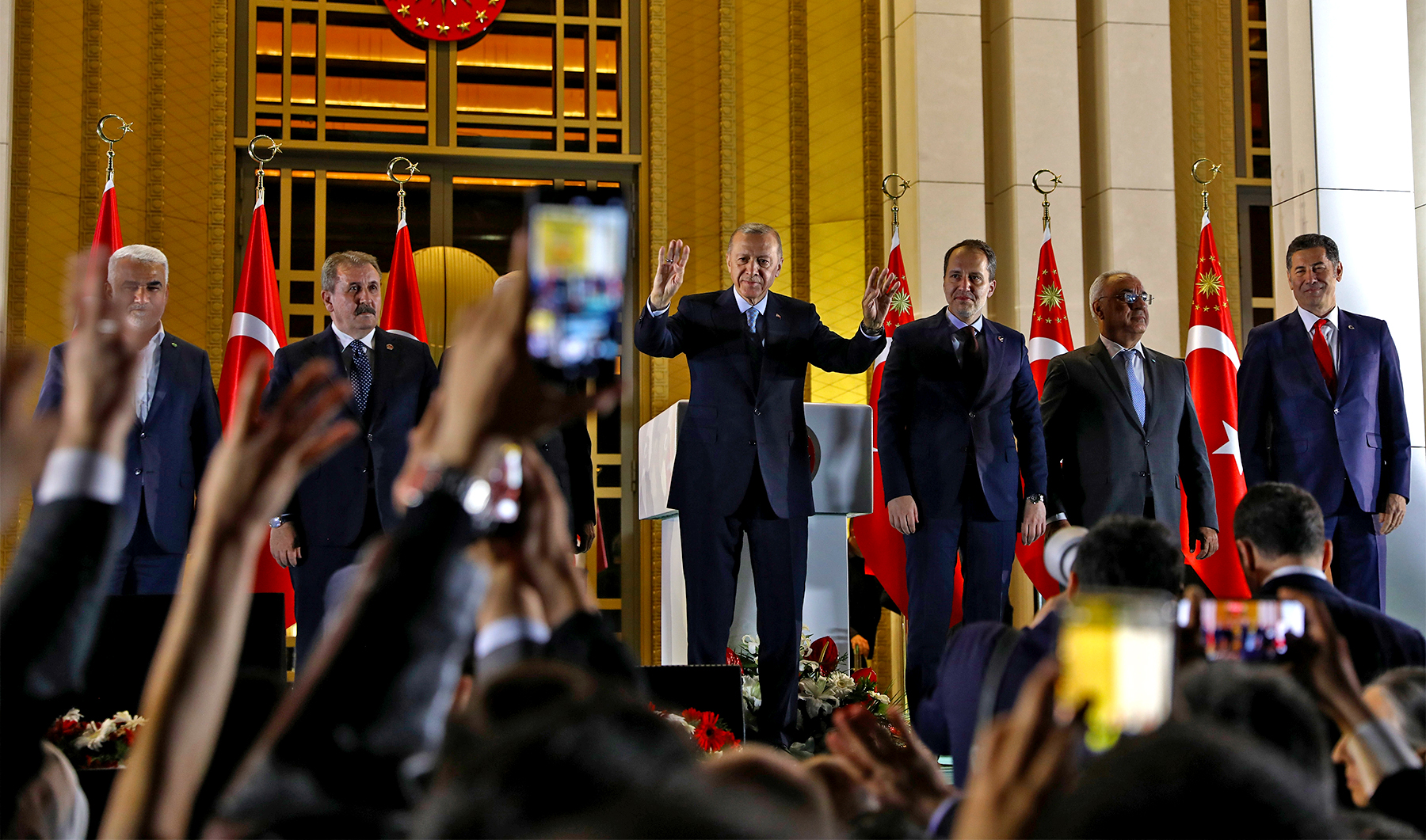 Turkish President and People's Alliance's presidential candidate Recep Tayyip Erdogan, center, gestures to supporters at the presidential palace, in Ankara, Turkey, on May 28, 2023. (AP)
