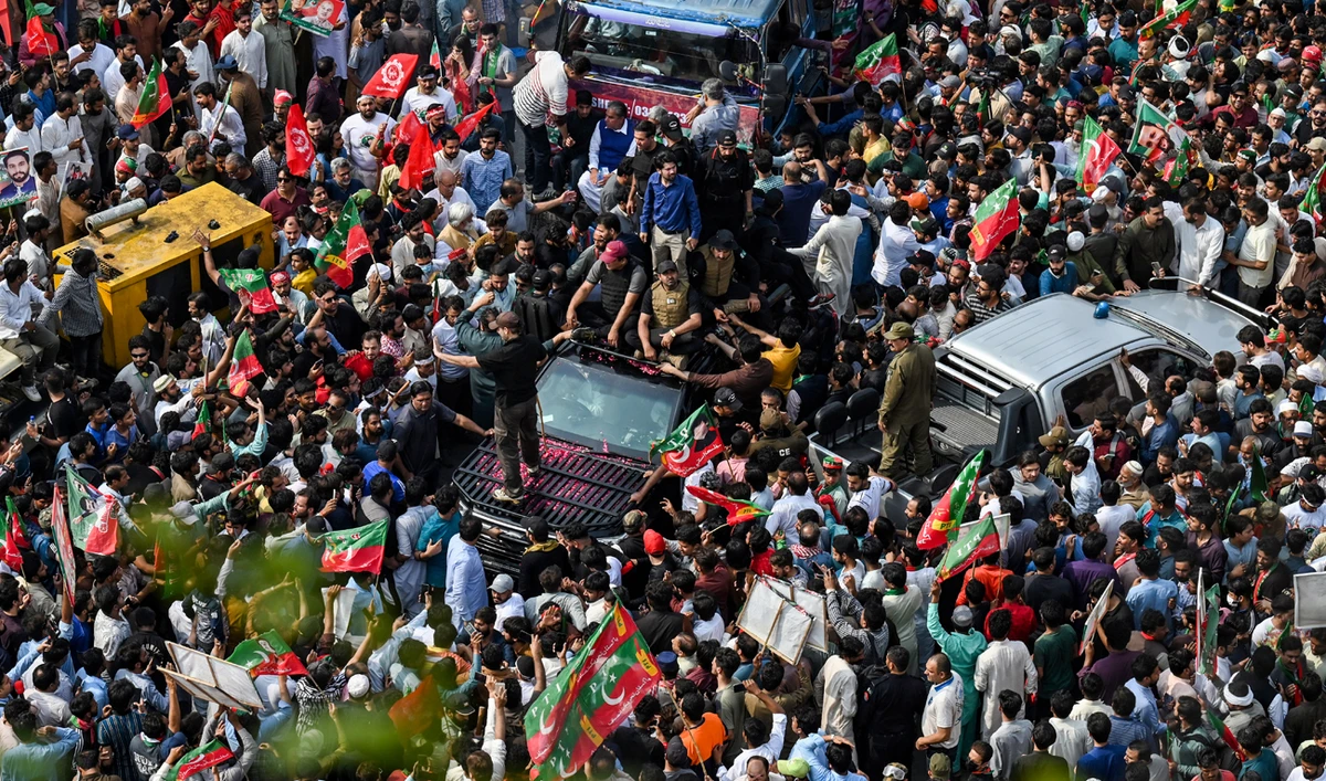In this picture, taken on May 1, 2023, activists of the Pakistan Tehreek-e-Insaf (PTI) party gather around the vehicle of former prime minister Imran Khan (inside c, vehicle) during a rally in Lahore. (Photo courtesy: AFP)