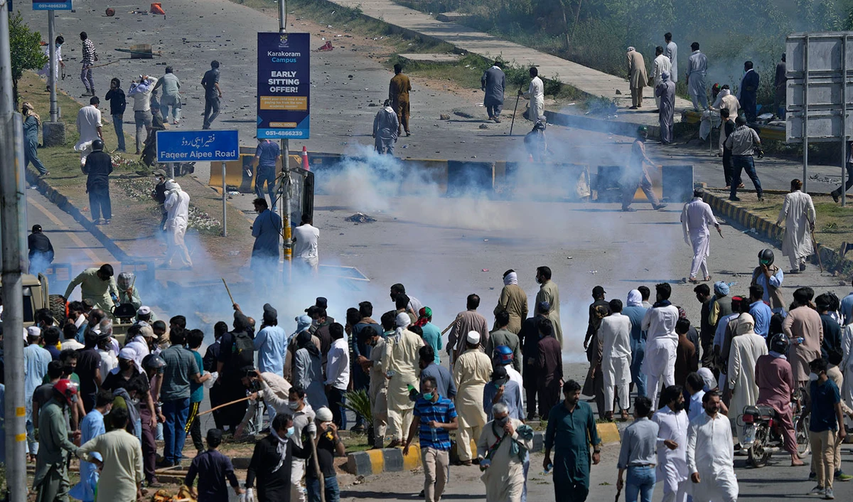 Police fire tear gas to disperse supporters of Pakistan's former Prime Minister Imran Khan during clashes, in Islamabad, Pakistan, on May 10, 2023. (AP)
