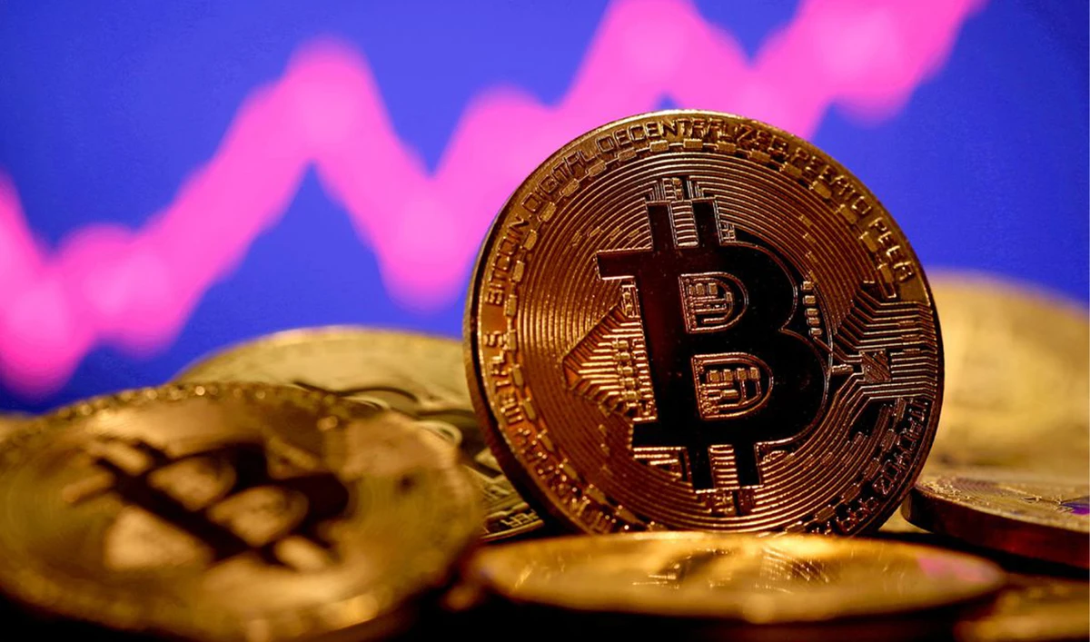 A representation of virtual currency Bitcoin is seen in front of a stock graph in this illustration taken January 8, 2021. (REUTERS/File)
