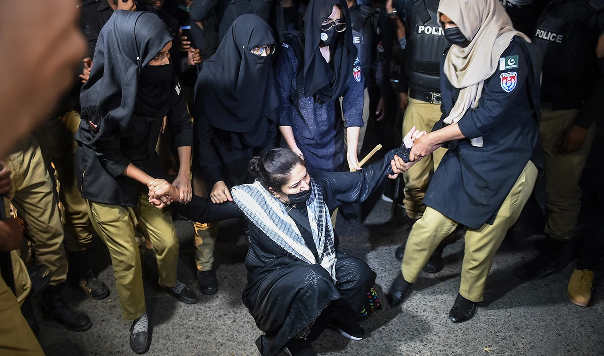 Policewomen detain a Pakistan Tehreek-e-Insaf (PTI) party activist and supporter of former Pakistan's Prime Minister Imran Khan during a protest against the arrest of their leader, in Karachi on May 10, 2023. (AFP/File)