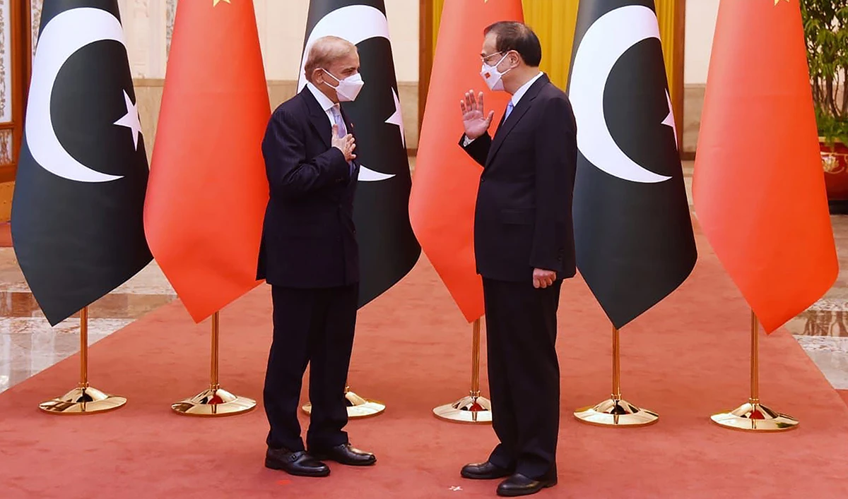 This handout picture taken and released by the Pakistan Prime Minister Office on November 2, 2022, shows Pakistan Prime Minister Shahbaz Sharif (L) speaking with China's Premier Li Keqiang (R) prior to their talks at the Great Hall of the People in Beijing, China. (AFP/File)