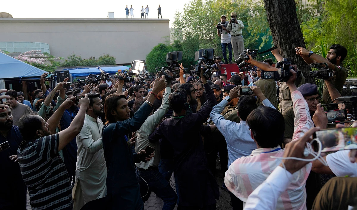 Members of the media conduct their television report in Imran Khan's house in Lahore, Pakistan, on May 19, 2023. (AP)