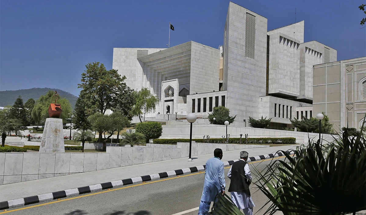 People walk past the Supreme Court of Pakistan in Islamabad, Pakistan, on April 4, 2022. (AP/File)