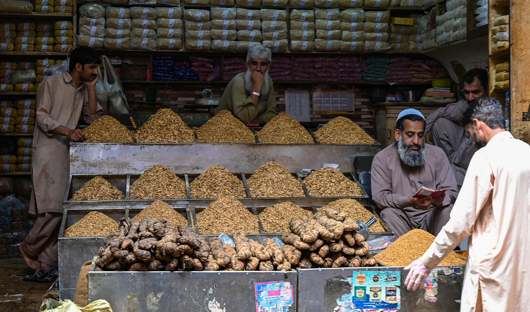 Shopkeepers wait for customers in a tobacco shop in a market in Rawalpindi, Pakistan, on June 1, 2023. (AFP)