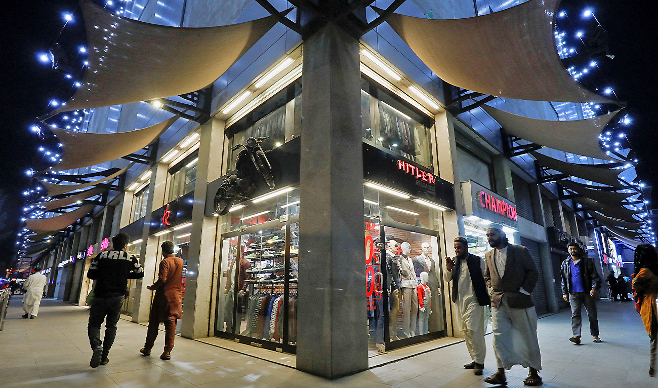 People walk outside shops at the Atrium Mall in Karachi, Pakistan, on January 3, 2023. (REUTERS)