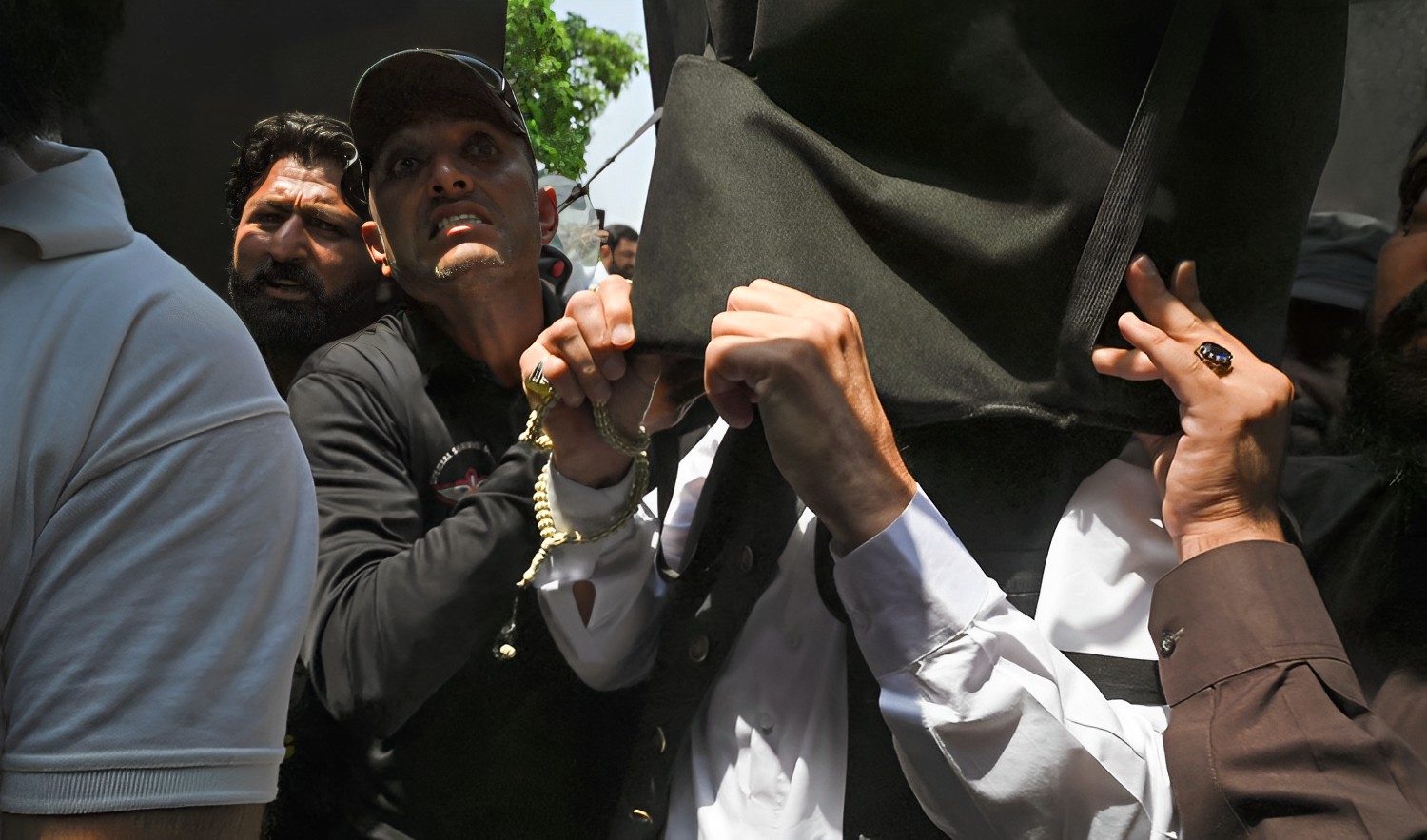 Former Pakistan Prime Minister Imran Khan, right, holds a protective shield upon his arrival at the High Court in Islamabad on June 8, 2023. (AFP)