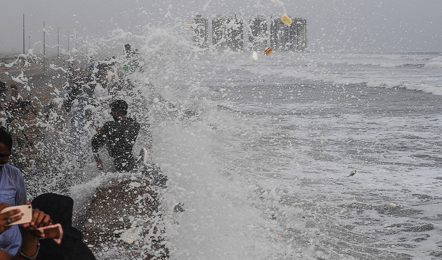 People gather on sea view during high tide of the Arabian Sea in Karachi, Pakistan on June 13, 2019. (AFP/File)