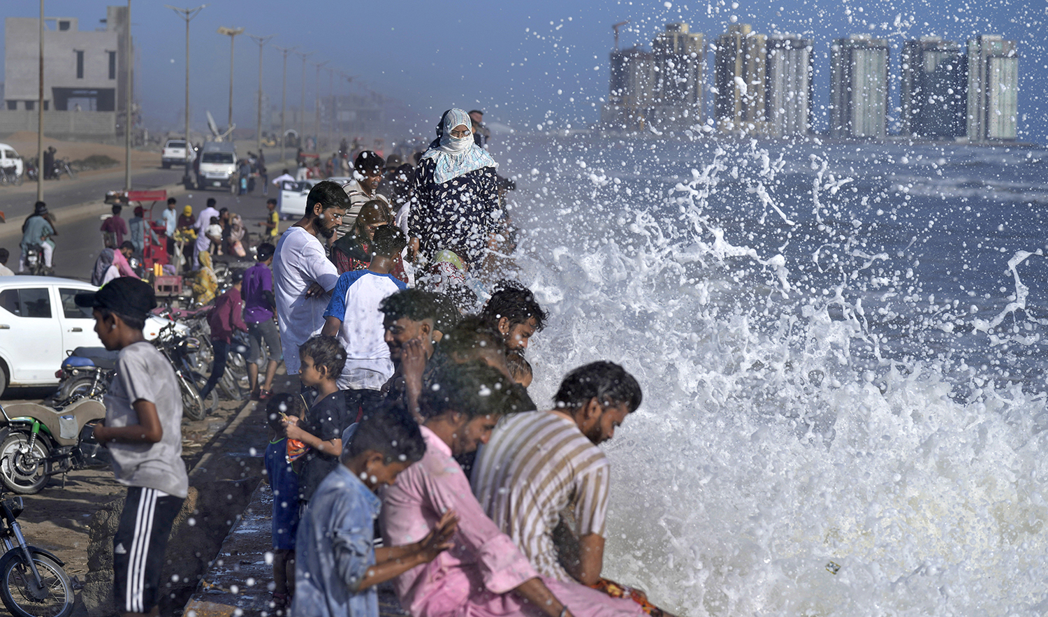 People enjoy high tide waves on the Arabian Sea, in Karachi, Pakistan, on June 11, 2023. (AP)