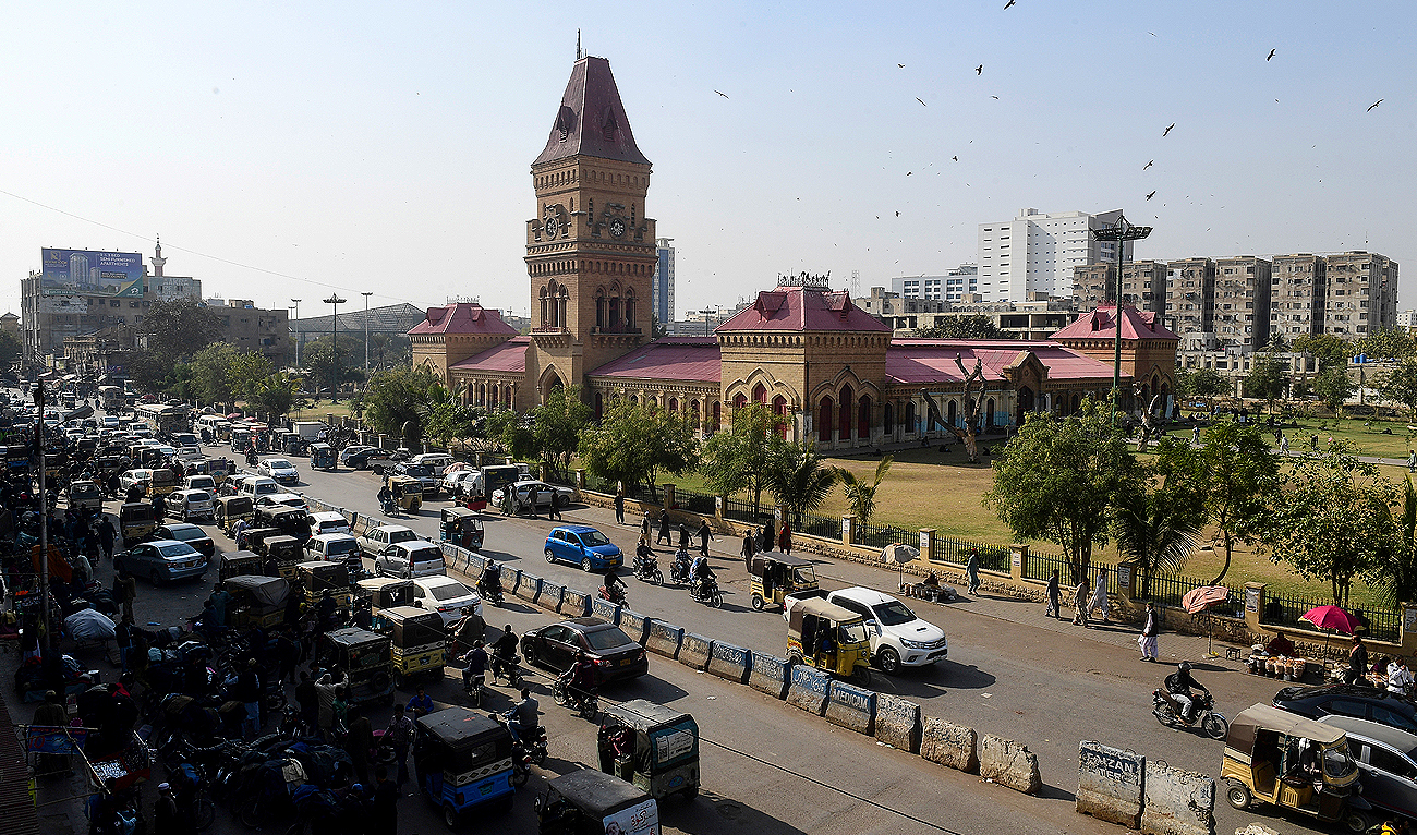 This picture taken on January 30, 2023 shows commuters passing Impress Market in Pakistan's port city of Karachi. (AFP/File)