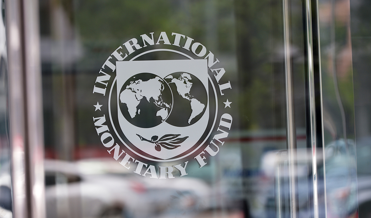 The seal of the International Monetary Fund is seen at the headquarters building in Washington, DC on July 5, 2015. (AFP/File)