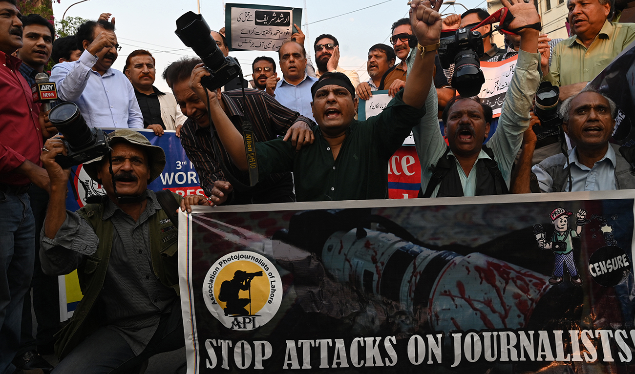 Pakistani photojournalists hold their cameras and shout slogans during a demonstration to mark World Press Freedom Day in Lahore on May 3, 2023. (AFP/File)