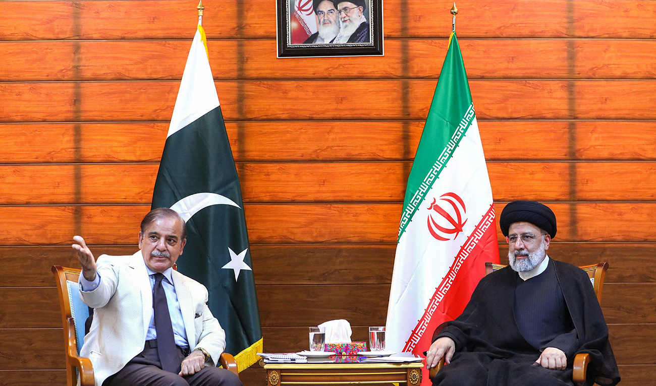 A handout picture provided by the Iranian presidency shows Iran's President Ebrahim Raisi (R) and Pakistan's Prime Minister Shahbaz Sharif meeting after a ceremony to inaugurate a new border market in the border city in Iran's southeastern border city of Pishin on May 18, 2023. (AFP/File)