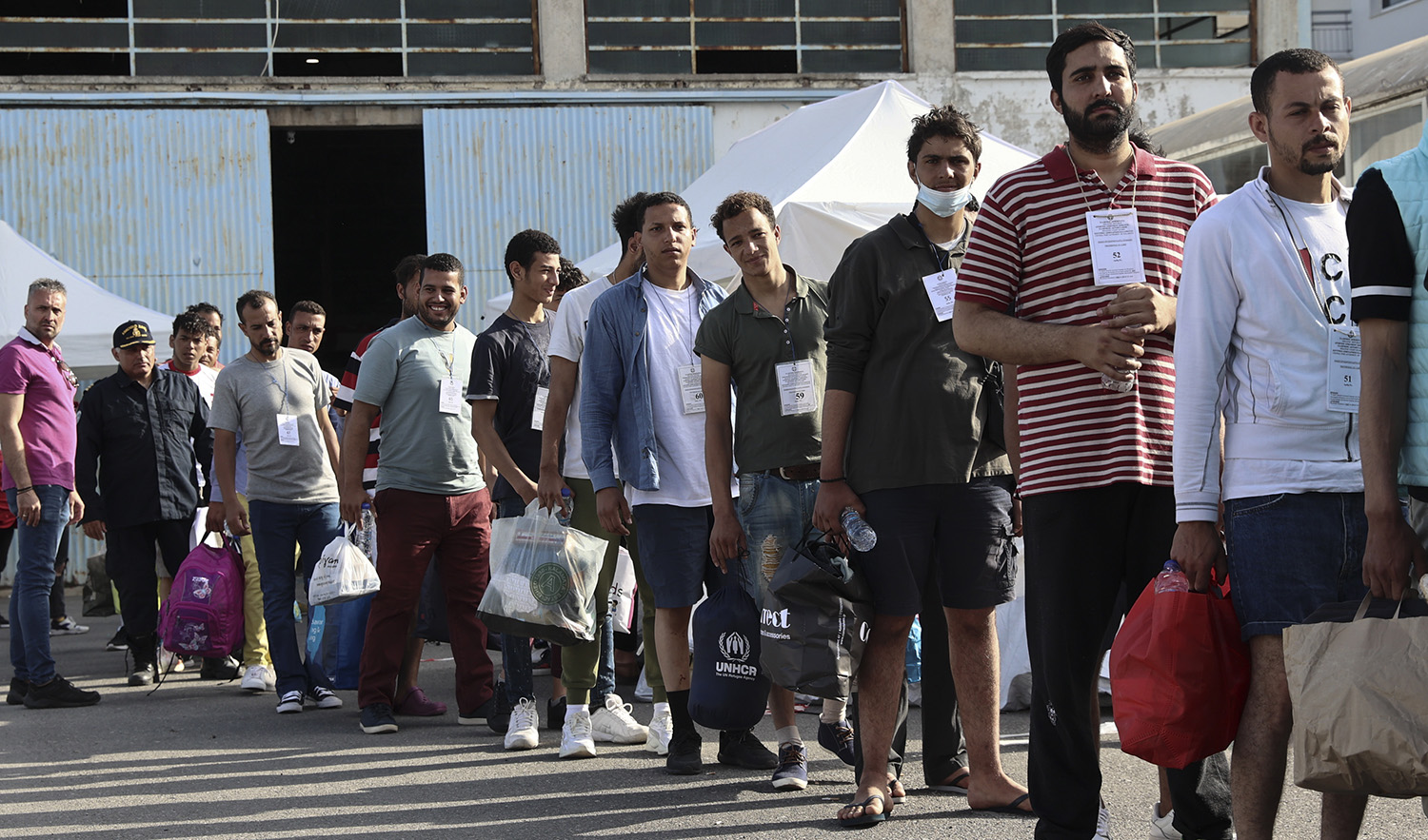 Survivors of latest tragical shipwreck prepare to board a bus to transfer to Athens at the port of Kalamata, Greece, on June 16, 2023. (InTime News via AP)