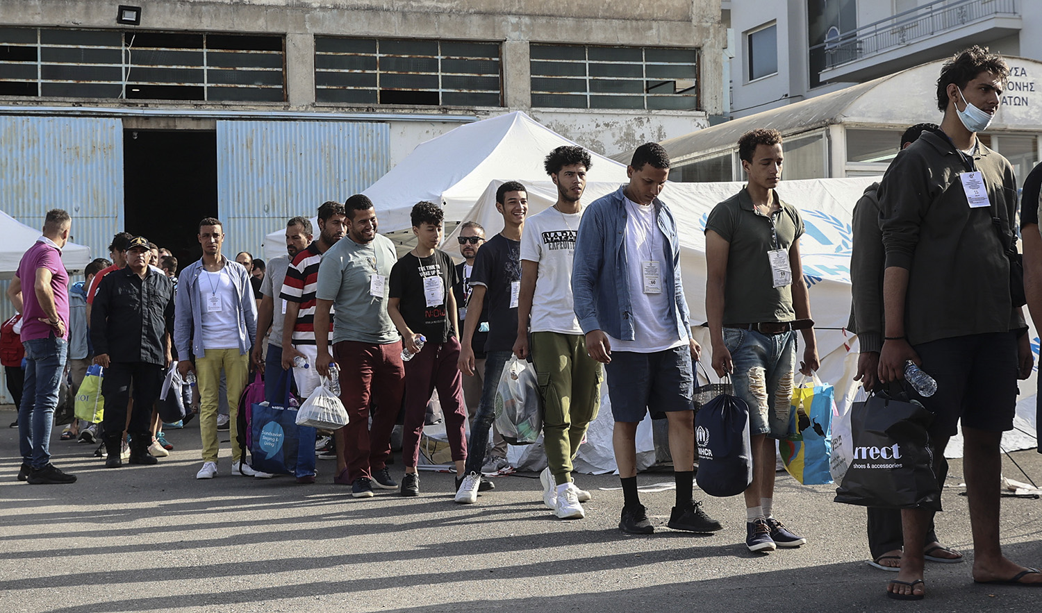 Survivors of latest tragical shipwreck prepare to board a bus to transfer to Athens at the port of Kalamata, Greece, on June 16, 2023. (InTime News via AP)