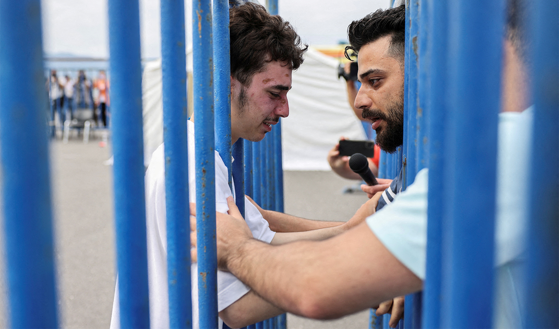 Syrian survivor Mohammad, 18, who was rescued with other refugees and migrants at open sea off Greece after their boat capsized, cries as he reunites with his brother Fadi, who came to meet him from Netherlands, at the port of Kalamata, Greece, on June 16, 2023. (REUTERS)