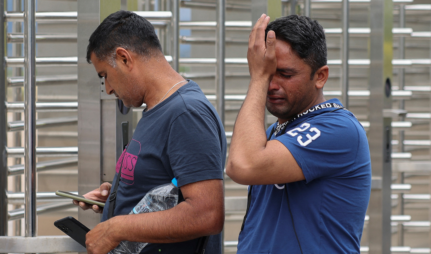 Hasan Ali from Pakistan, whose brother Fahad, 21, is missing after a boat carrying refugees and migrants capsized at open sea off Greece, cries outside a reception and identification camp in Malakasa, Greece, on June 17, 2023. (REUTERS)