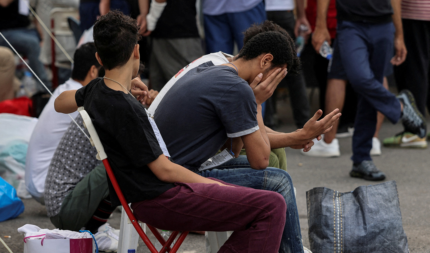 Migrants, survivors of a deadly shipwreck after a boat capsized at open sea off Greece, wait to board a bus as they are being transferred to Athens from the port of Kalamata, Greece, on June 16, 2023. (REUTERS)